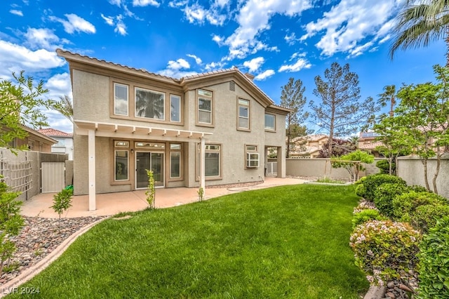 back of house featuring a yard and a patio area