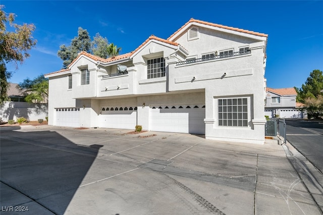 view of front of property featuring a garage and a balcony