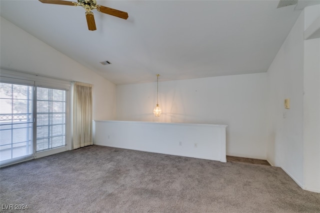 empty room featuring ceiling fan, light colored carpet, and vaulted ceiling