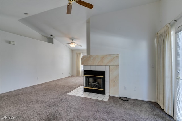 unfurnished living room featuring lofted ceiling, light carpet, a tile fireplace, and ceiling fan