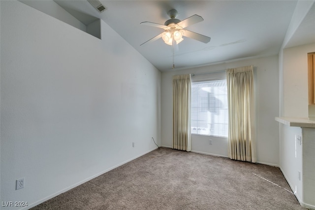 unfurnished room with ceiling fan and light colored carpet