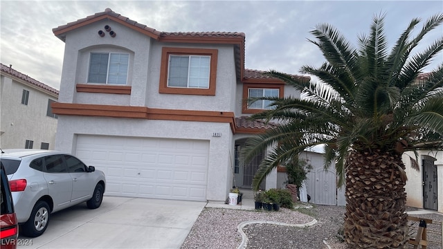 mediterranean / spanish house with a garage