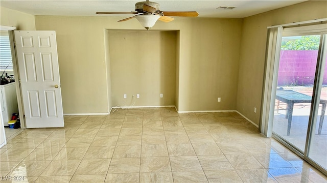 tiled spare room with ceiling fan