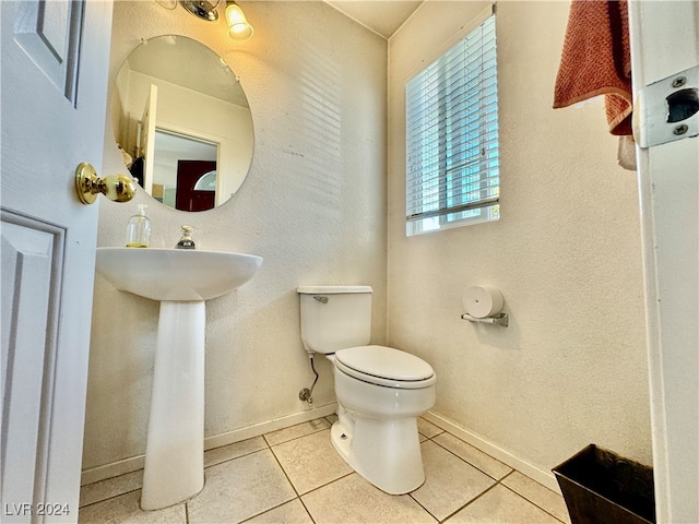 bathroom with toilet and tile patterned floors