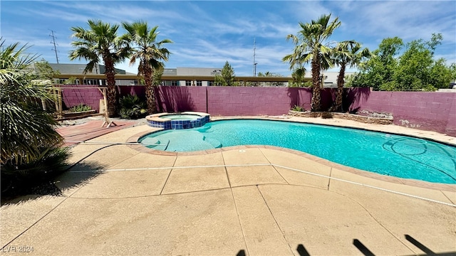 view of pool featuring an in ground hot tub and a patio