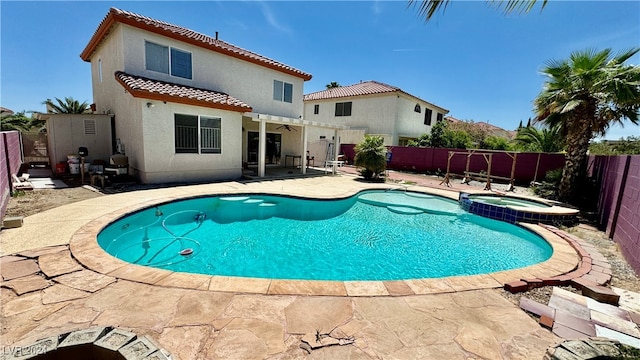 view of pool with an in ground hot tub and a patio area