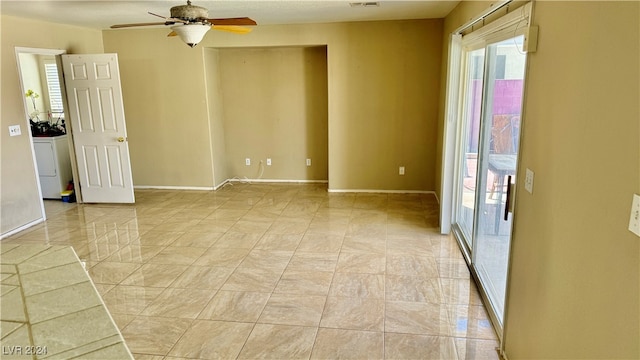 unfurnished room with washer / dryer and ceiling fan