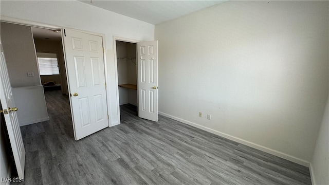 unfurnished bedroom with a closet and wood-type flooring