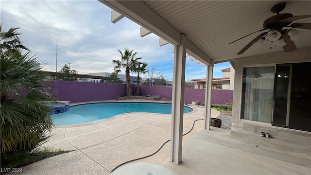 view of swimming pool with a patio and ceiling fan