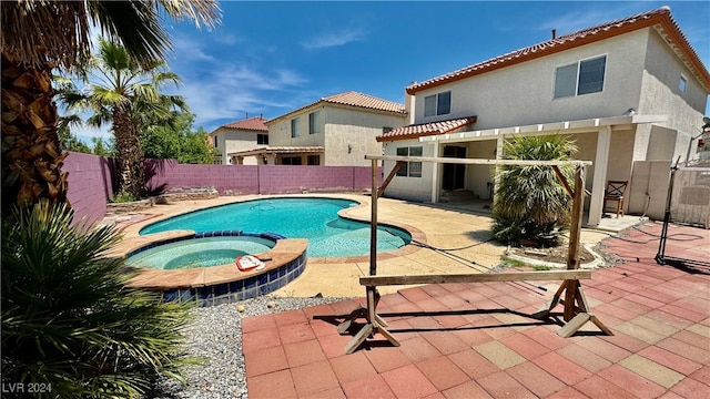 view of pool featuring an in ground hot tub and a patio