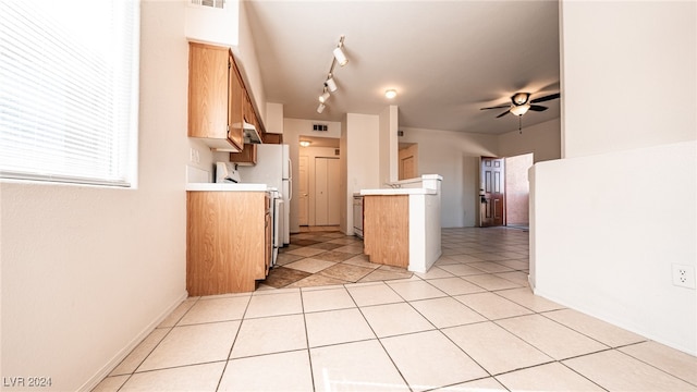 kitchen with track lighting, white refrigerator, light tile patterned floors, and ceiling fan