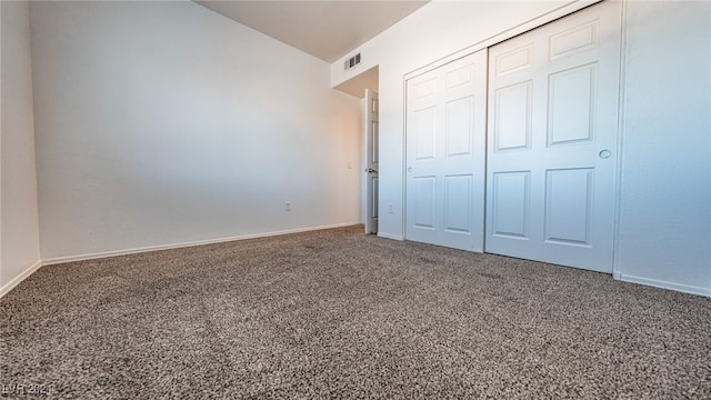 unfurnished bedroom with a closet and carpet flooring