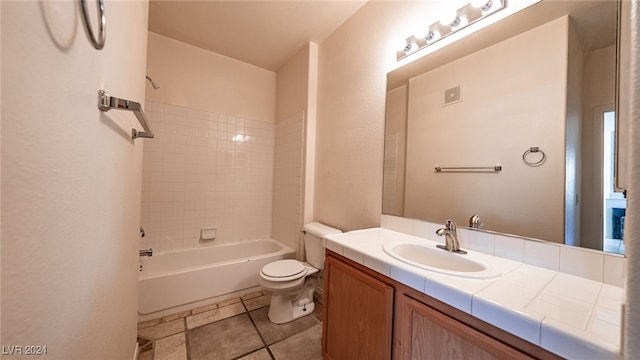 full bathroom featuring toilet, tiled shower / bath, and vanity