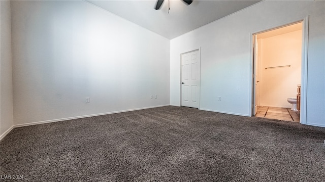 unfurnished bedroom featuring connected bathroom, ceiling fan, carpet, and lofted ceiling