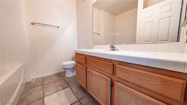 full bathroom featuring toilet, tiled shower / bath combo, and vanity