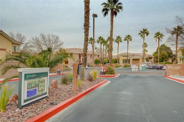 1050 E Cactus Ave Unit 2106, Las Vegas, NV 89183 - view of asphalt road with a gate, curbs, a gated entry, and a residential view