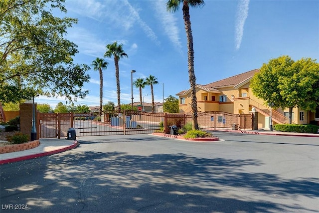 1050 E Cactus Ave Unit 2106, Las Vegas, NV 89183 - view of asphalt street featuring a gate, curbs, street lighting, and a gated entry
