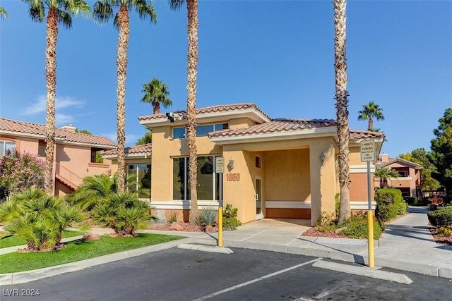 1050 E Cactus Ave Unit 2106, Las Vegas, NV 89183 - view of front facade with stucco siding, uncovered parking, and a tile roof