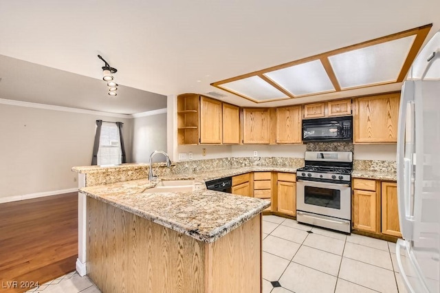 kitchen with kitchen peninsula, ornamental molding, sink, black appliances, and light tile patterned floors