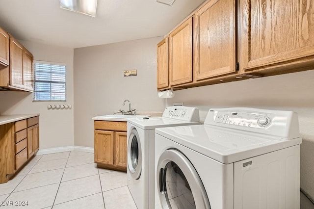 laundry area with cabinets, separate washer and dryer, light tile patterned flooring, and sink