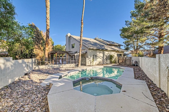 view of pool with a pergola and an in ground hot tub