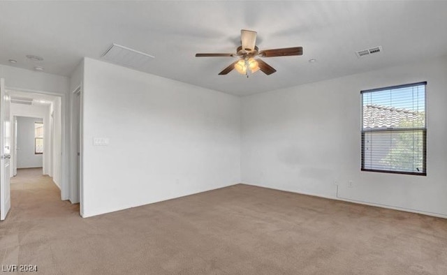 spare room with light carpet and ceiling fan