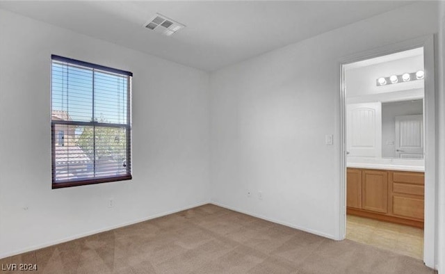 spare room with light colored carpet