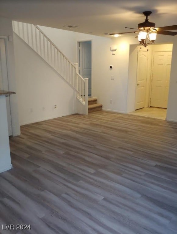 unfurnished living room with hardwood / wood-style floors and ceiling fan