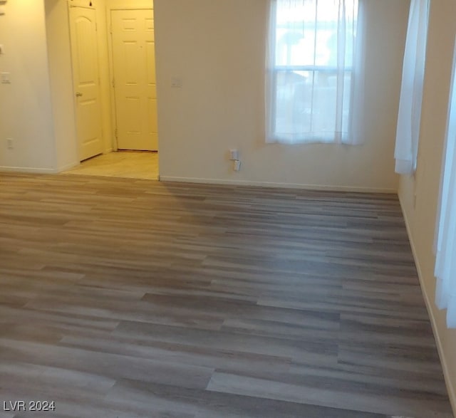 unfurnished room featuring dark wood-type flooring