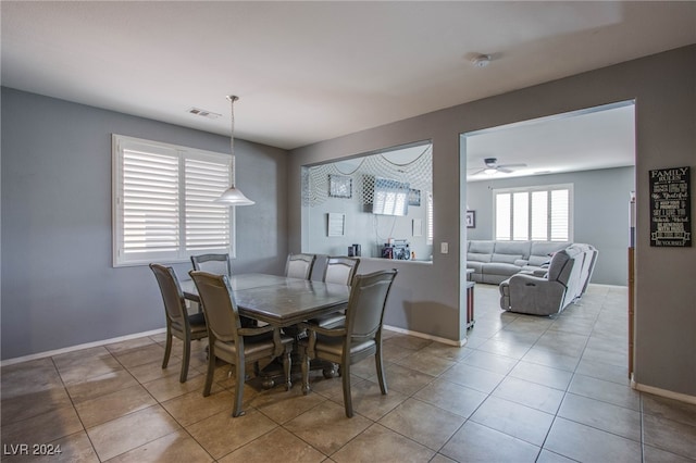 tiled dining area with ceiling fan