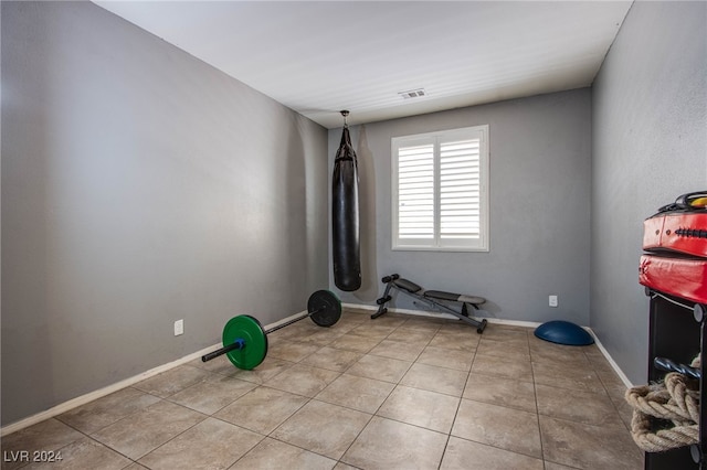 workout room with light tile patterned floors