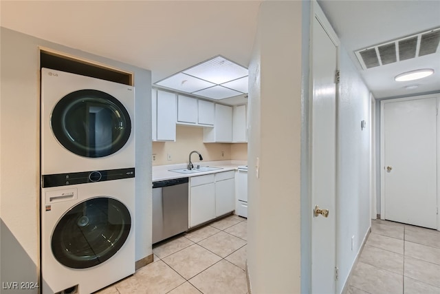 washroom with stacked washing maching and dryer, sink, and light tile patterned floors