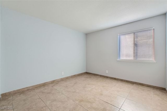 spare room with light tile patterned floors