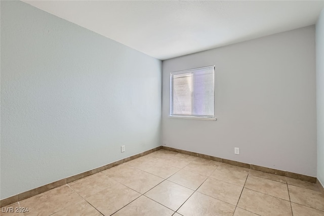 unfurnished room featuring light tile patterned flooring