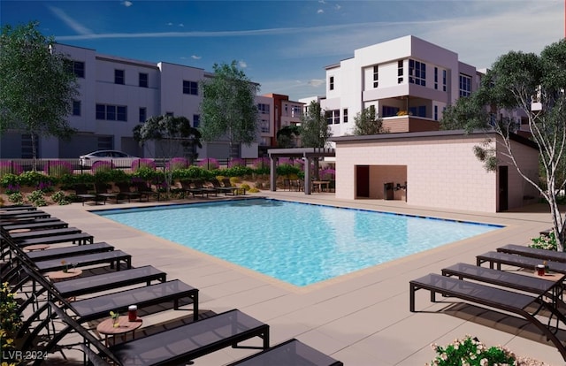 community pool with a patio and fence