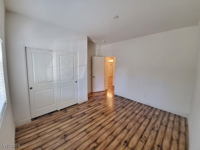 unfurnished bedroom with a closet and wood-type flooring