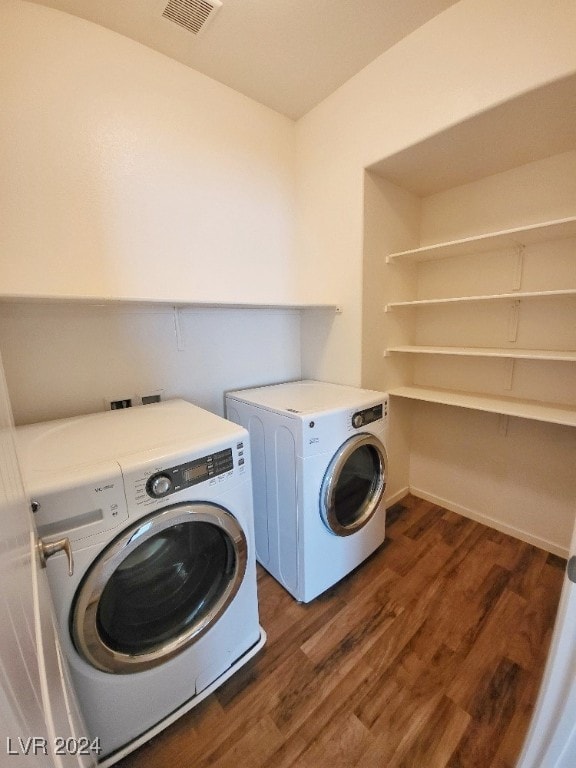 washroom featuring dark wood-type flooring and washer and dryer