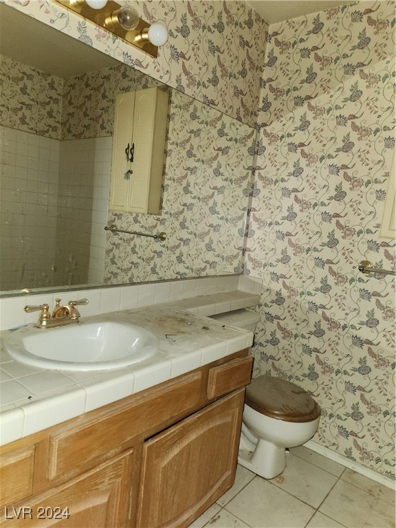 bathroom featuring vanity, toilet, and tile patterned flooring