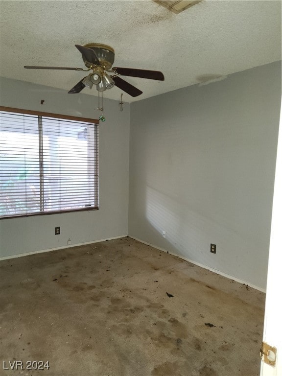 spare room with a textured ceiling and ceiling fan