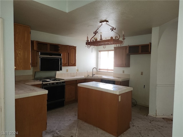 kitchen with black appliances, sink, a textured ceiling, tile counters, and light tile patterned floors