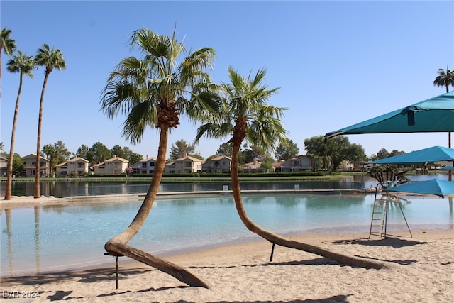 view of swimming pool featuring a water view