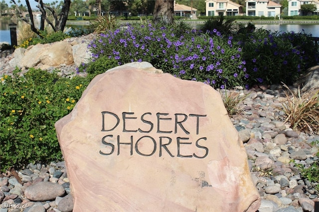 community / neighborhood sign with a water view