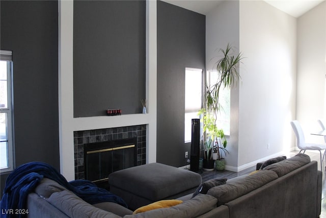 living room featuring a tiled fireplace