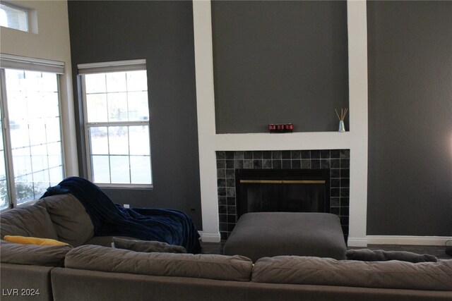 living room with a tile fireplace