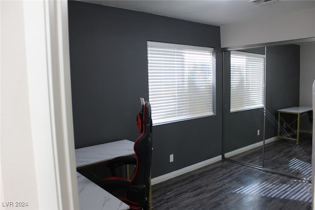 bedroom featuring dark wood-type flooring and a closet