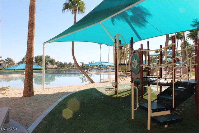 view of jungle gym featuring a water view