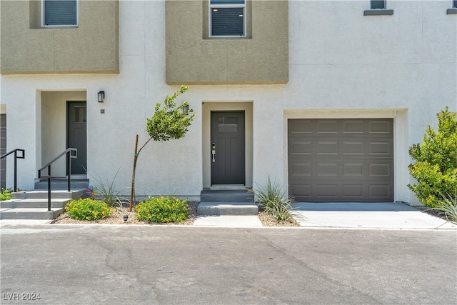 view of exterior entry with a garage