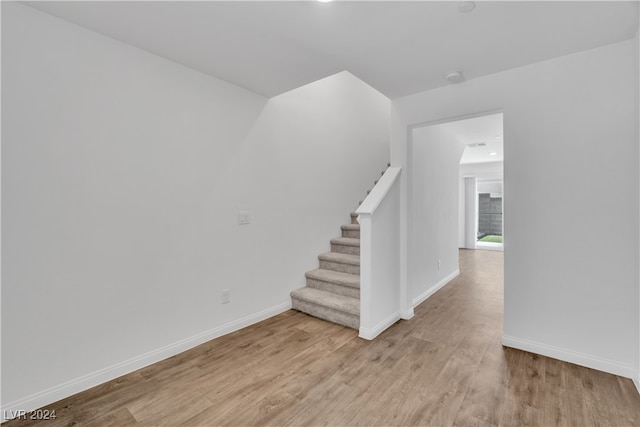 staircase with wood-type flooring