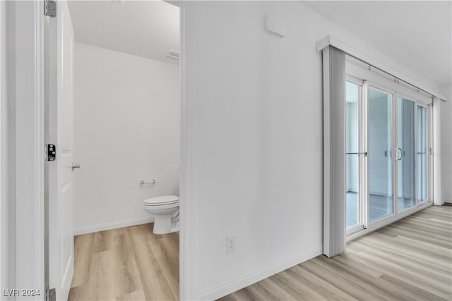 bathroom with toilet and hardwood / wood-style floors