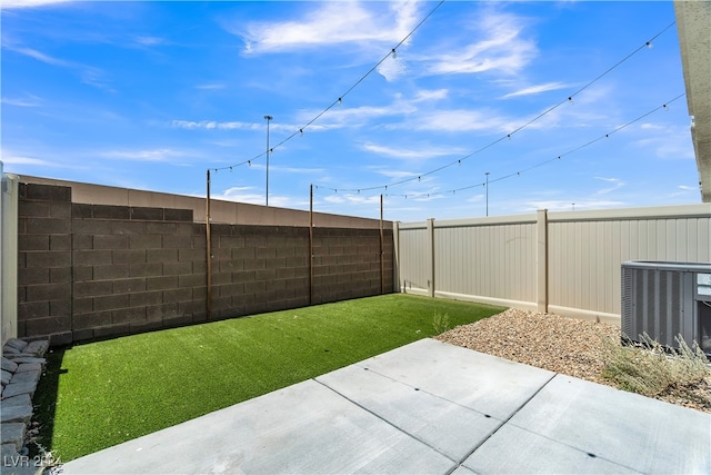 view of yard with a patio area and central AC unit